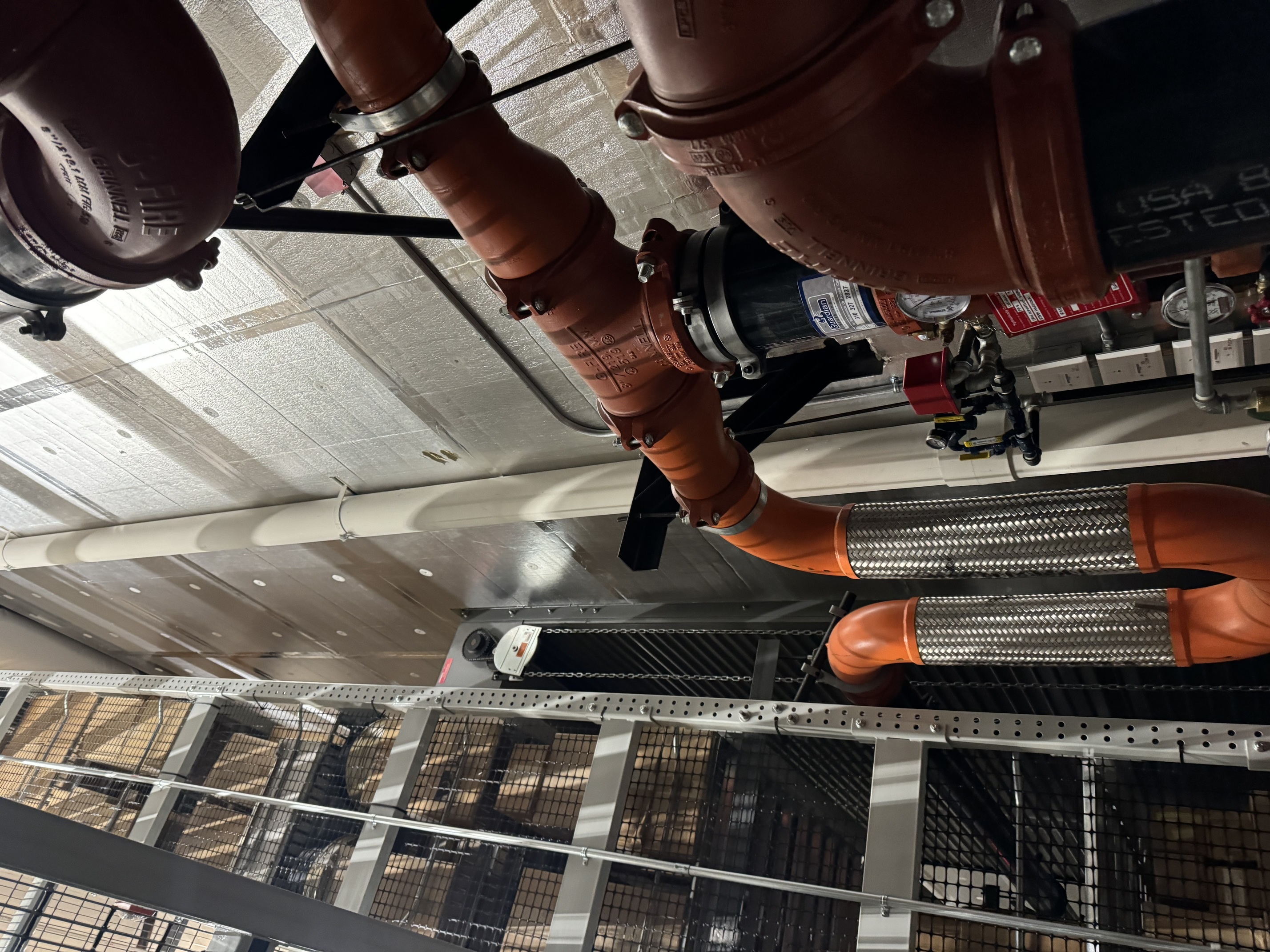 Commercial fire suppression piping system in building ceiling