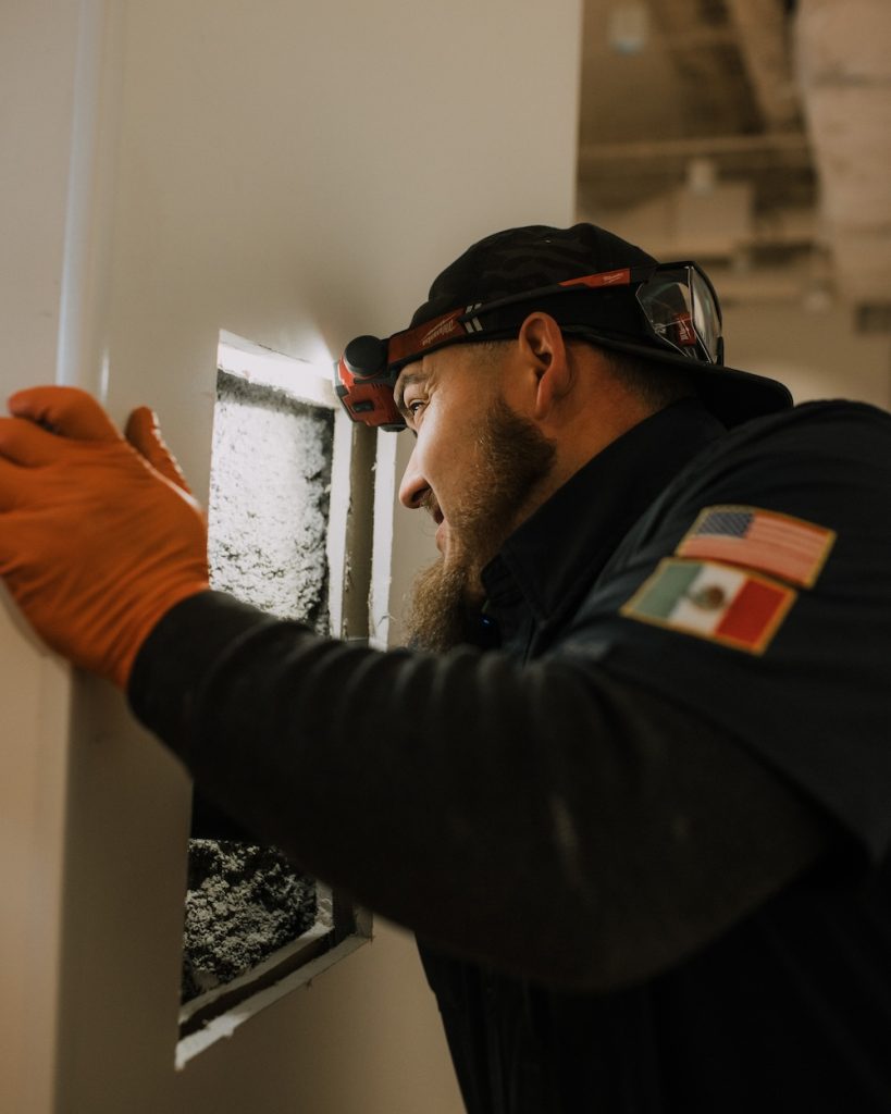California Coast Plumbers technician replacing a damaged section of cast iron sewer line with durable, modern piping