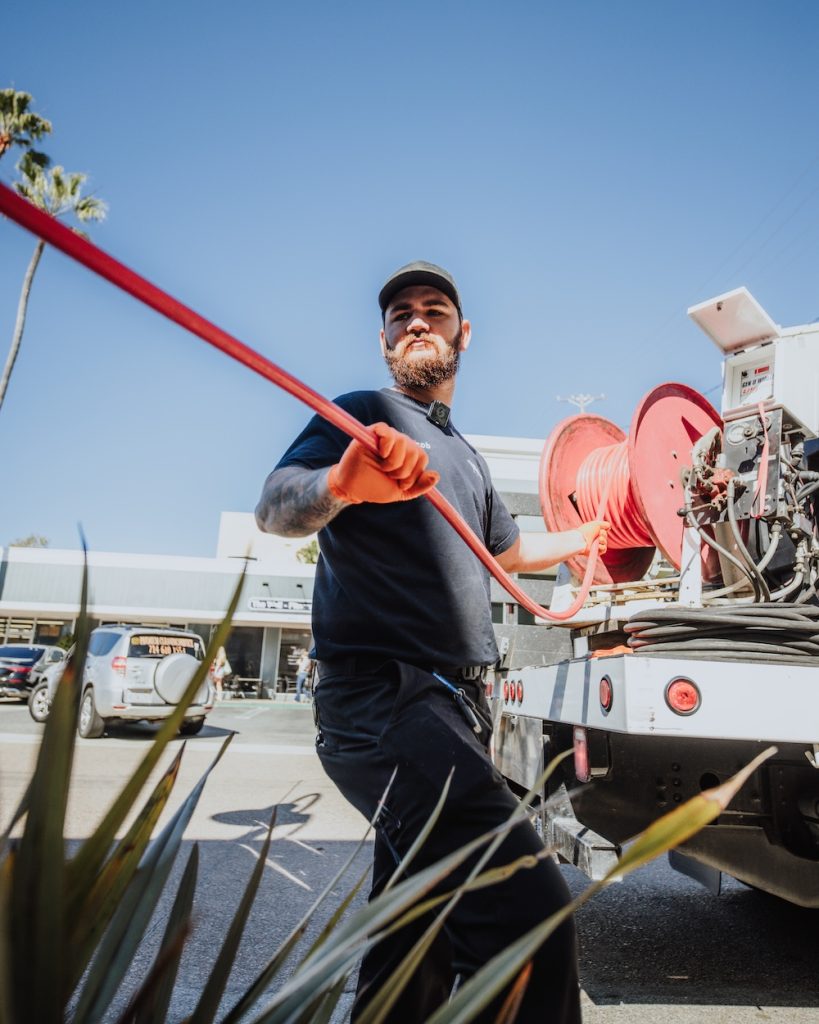 California Coast Plumbers technician preparing to clean and restore proper drainage in a commercial property