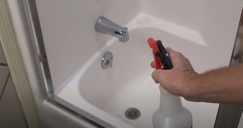 Spraying CLR on taps with calcium deposit