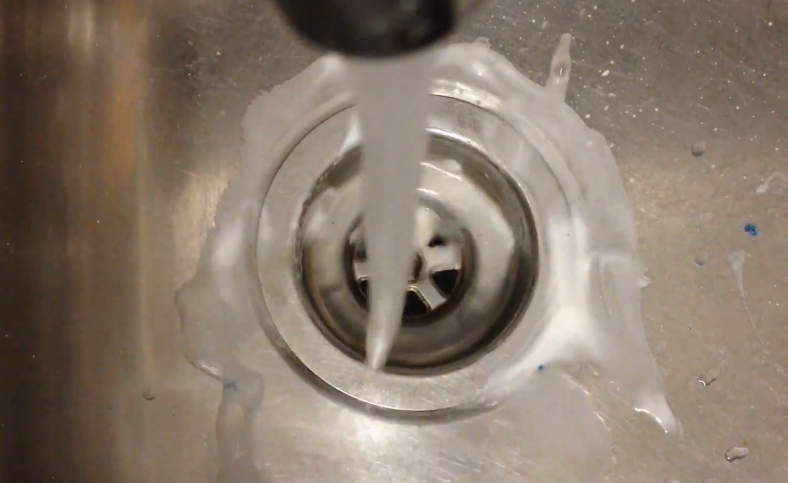 Cleaning sink strainer basket with hot water