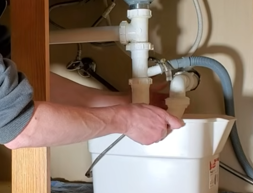 Disconnecting plumbing fittings underneath the kitchen sink