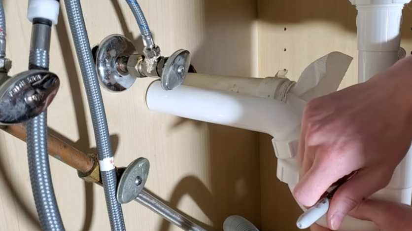 Checking and cutting long piping under the new sink